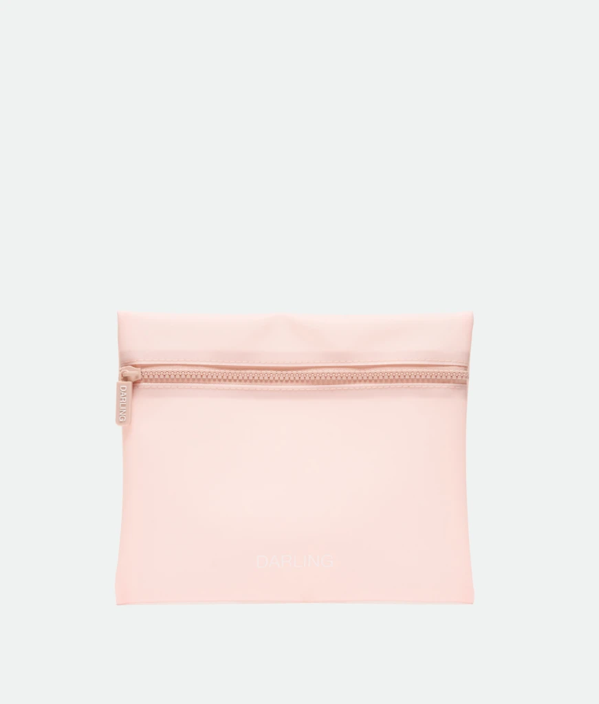 Light pink zippered pouch with visible zipper and the word DARLING printed faintly on the front.