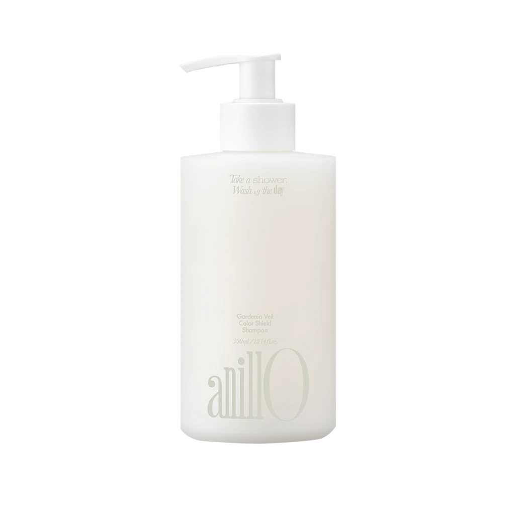 White shampoo bottle with a pump dispenser, featuring faint printed text on the label.