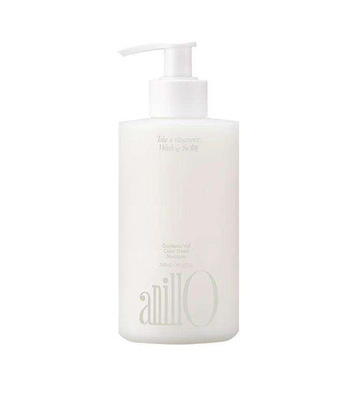 White shampoo bottle with a pump dispenser, featuring faint printed text on the label.