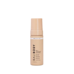 Peach-colored self-tanning mousse bottle with pump top, showing the label 'Dark Streak Free' and 'Self Tanning Mousse' on a white background