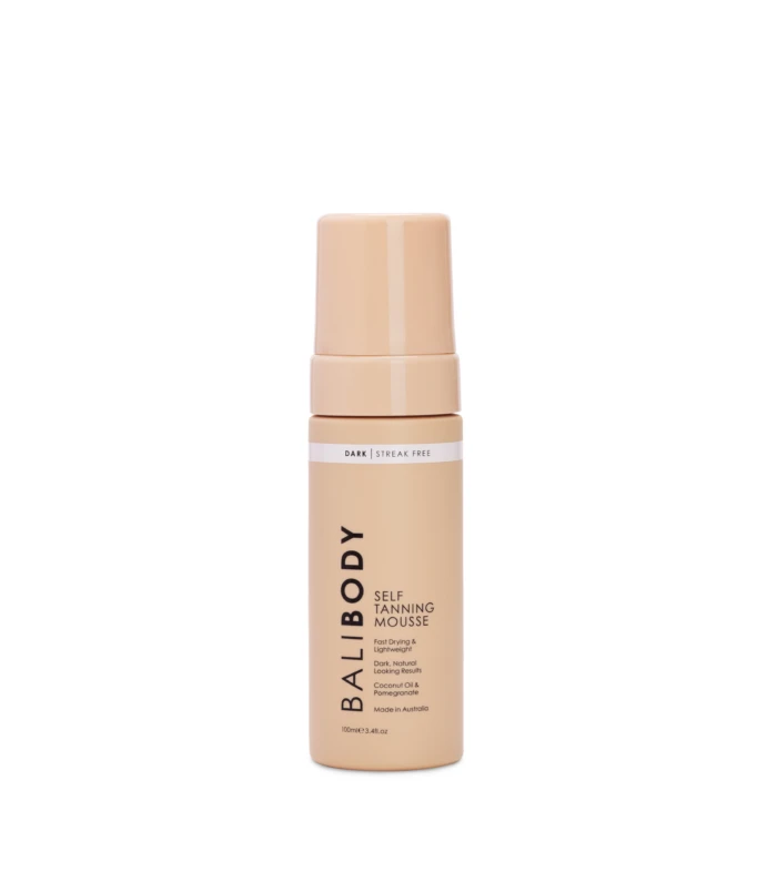 Peach-colored self-tanning mousse bottle with pump top, showing the label 'Dark Streak Free' and 'Self Tanning Mousse' on a white background