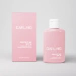 Pink sunscreen bottle and matching pink box labeled 'DARLING' on a light gray background.