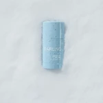Blue lip balm tube on snowy surface with water droplets; reads 'DARLING' and 'Shield-Me SPF 50+'