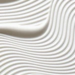 Close-up of smooth white wavy ridges forming an abstract pattern.