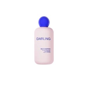 Pink bottle of Darling Multi-Biotics hydrating and balancing body lotion with a blue cap against a black background