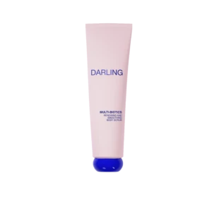 Pink cylindrical tube labeled DARLING with a blue cap at the bottom, advertising Multi-Biotics Renewing and Smoothing Body Scrub against a black background.