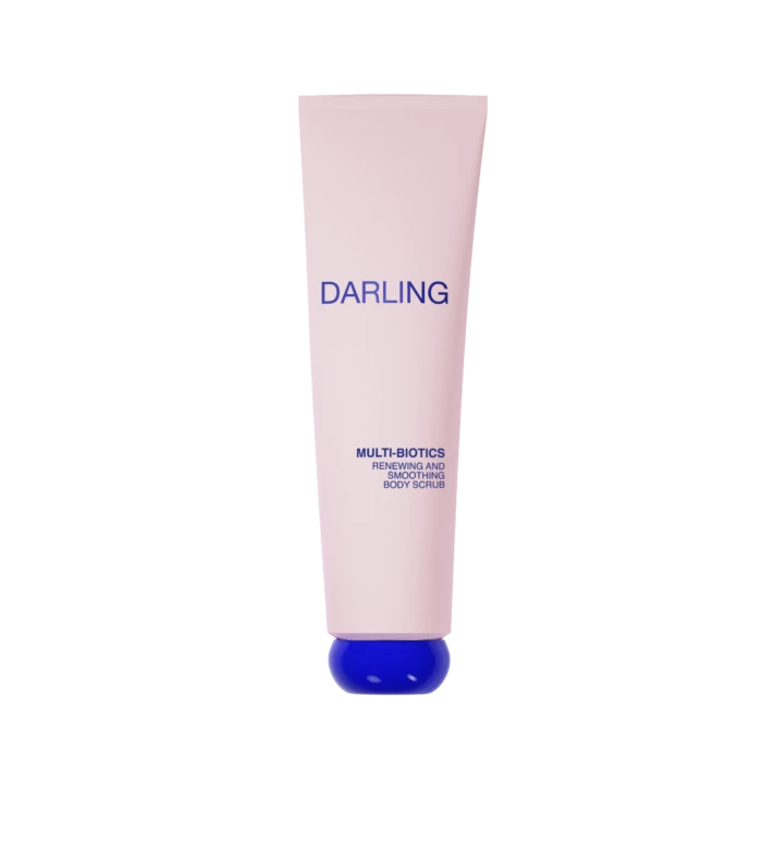 Pink cylindrical tube labeled DARLING with a blue cap at the bottom, advertising Multi-Biotics Renewing and Smoothing Body Scrub against a black background.