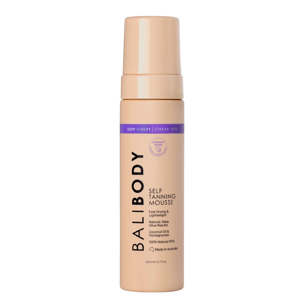 Peach-colored self-tanning mousse bottle with a purple label reading 'DEEP VIOLET | STREAK FREE' and upright orientation.