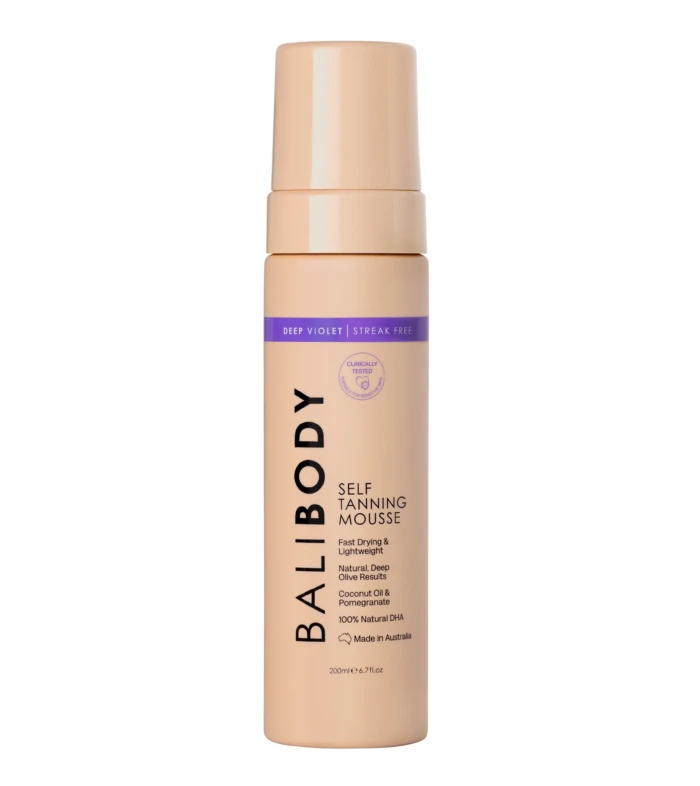 Peach-colored self-tanning mousse bottle with a purple label reading 'DEEP VIOLET | STREAK FREE' and upright orientation.