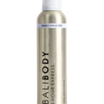 A tall cylindrical metallic spray bottle with a white cap and a light band around the neck reading 'DARK | STREAK FREE'