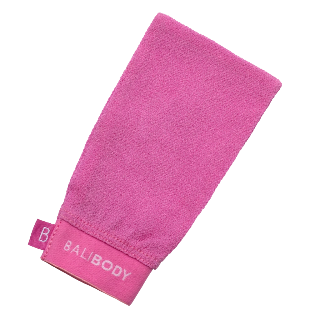 Pink terry-cloth towel folded diagonally on a white background, showing its textured surface and edge tag.