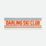 Knitted headband in cream with blue and red stripes, text reads ‘DARLING SKI CLUB’ in red.