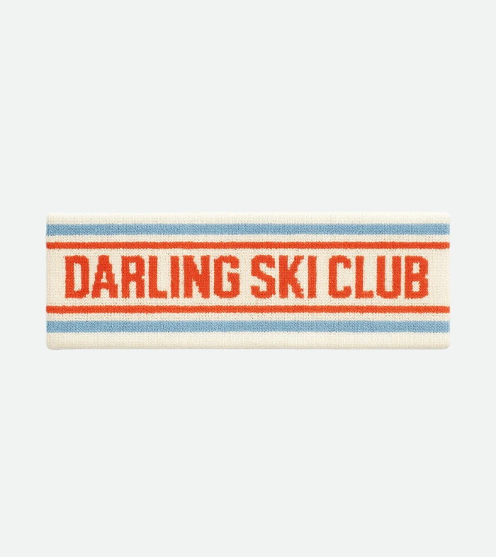 Knitted headband in cream with blue and red stripes, text reads ‘DARLING SKI CLUB’ in red.