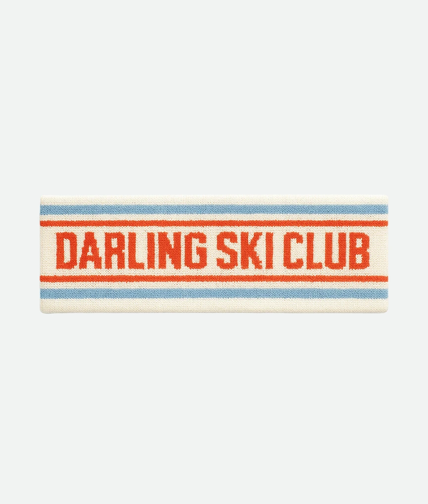 Knitted headband in cream with blue and red stripes, text reads ‘DARLING SKI CLUB’ in red.