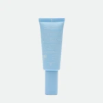Light blue sunscreen tube standing upright with a ridged cap; label mentions SPF 50+ and dermatologically tested text visible on the tube.