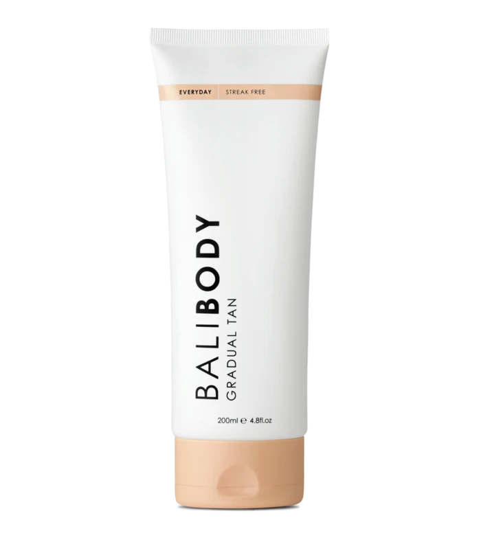 White tube of gradual tan lotion, labeled 'Body Gradual Tan' with a peach-cap at the bottom and a light peach band near the top; 200 ml container.