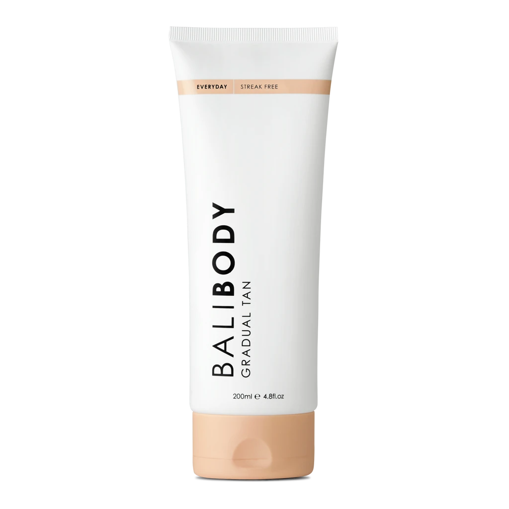 White tube of gradual tan lotion, labeled 'Body Gradual Tan' with a peach-cap at the bottom and a light peach band near the top; 200 ml container.