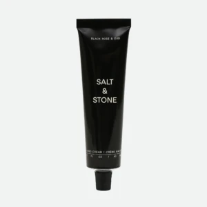 Tall black Salt & Stone hand cream tube with white text, photographed vertically.