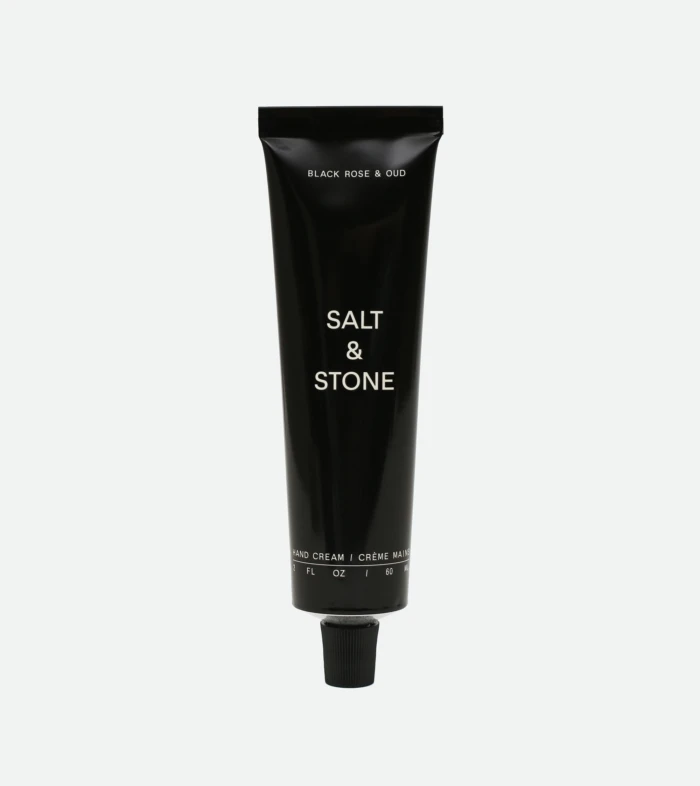 Tall black Salt & Stone hand cream tube with white text, photographed vertically.