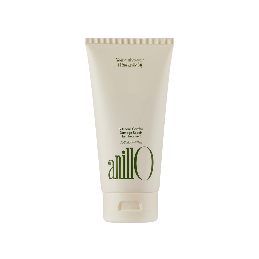 Cream-colored tube of Anillo Patchouli Garden Damage Repair Hair Treatment (150 ml) shown upright, front view with green logo text on the bottle.