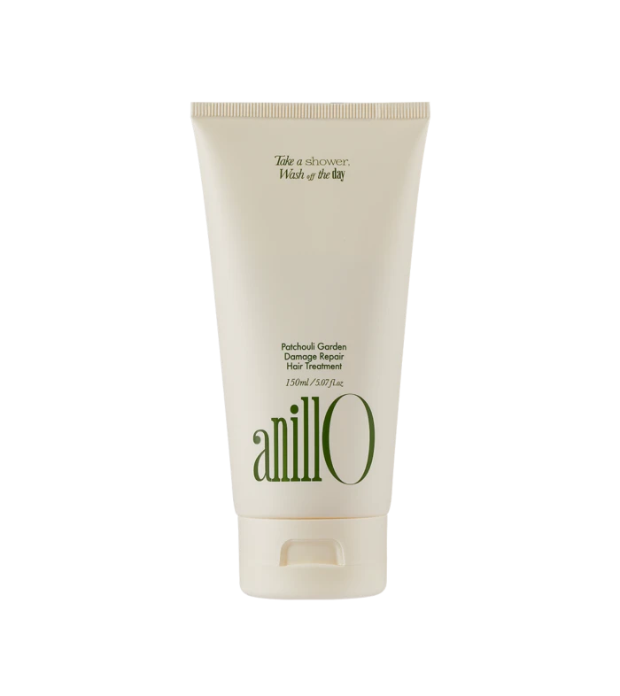 Cream-colored tube of Anillo Patchouli Garden Damage Repair Hair Treatment (150 ml) shown upright, front view with green logo text on the bottle.