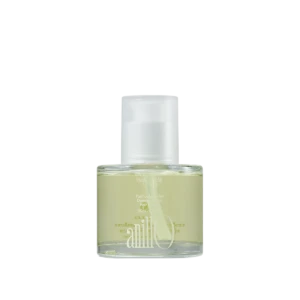 Perfume bottle with pale yellow liquid and a white spray cap on a white background, angled to the left.