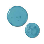 Two blue circular petri dishes containing liquid—one large with droplets, one smaller with bubble formations.