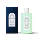 Blue box beside a mint-green BRIODERME Acne Derma Wash bottle with a white label on a white background.