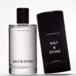 Two Salt & Stone deodorant bottles standing side by side on a white background (silver and black packaging).