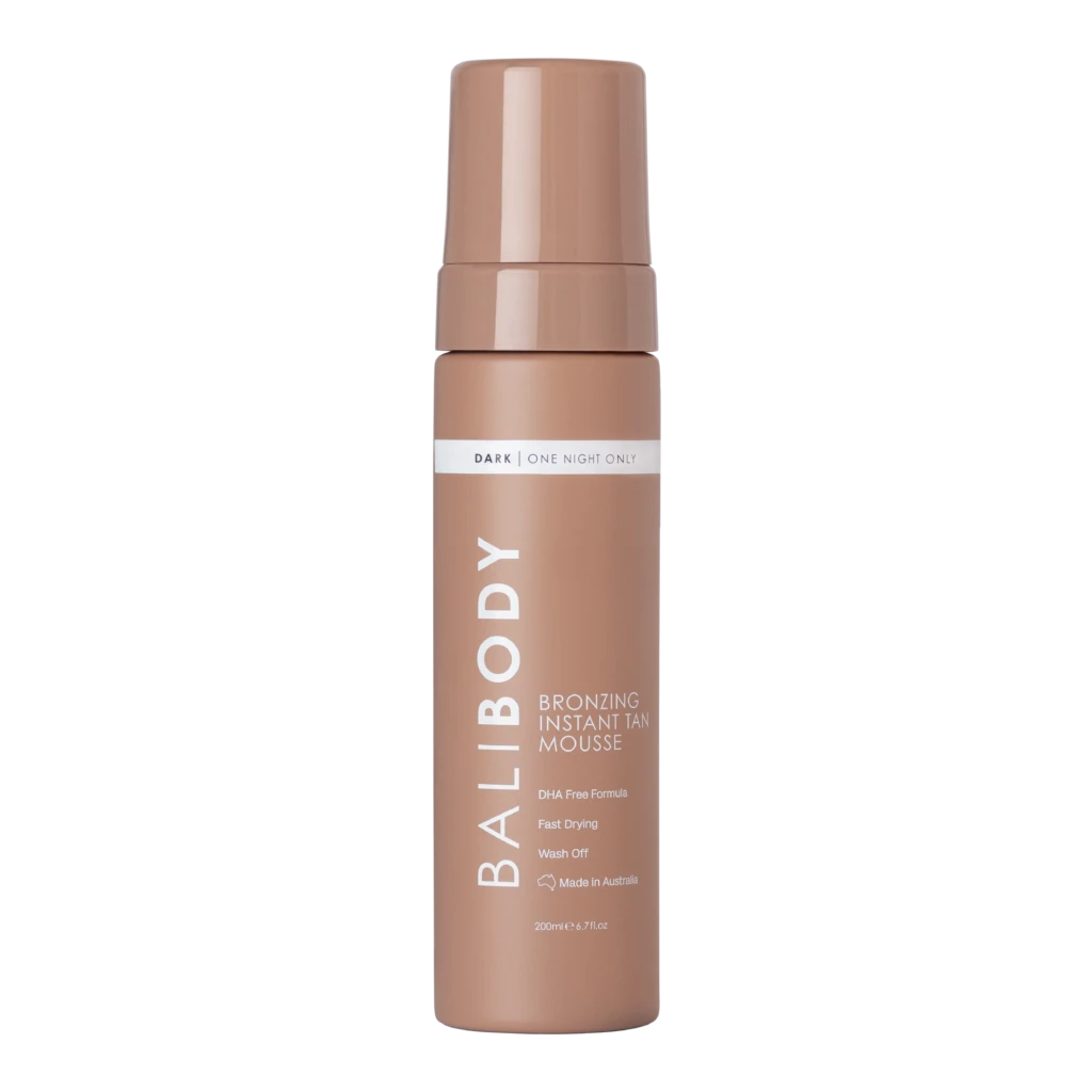 Tall bronze self-tanner mousse bottle with cap, label reads 'Dark | One Night Only' and 'Bronzing Instant Tan Mousse'