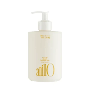 White pump lotion bottle with gold text, labeled 'anill0' (Amber 528 scented hand & body lotion), single-product shot on white background.