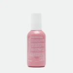 Front-view of a pink hair spray bottle with a white cap, label facing forward.