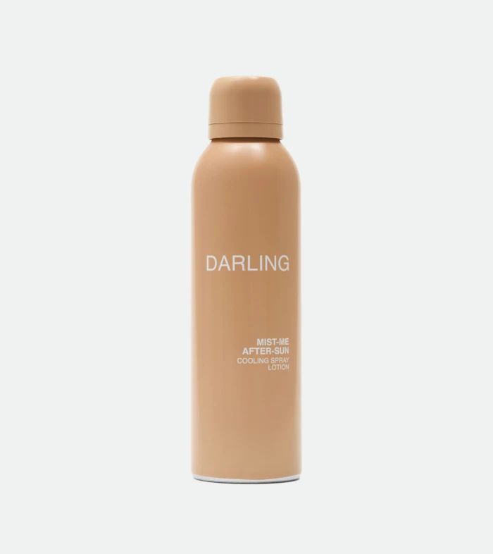 Peach-colored spray bottle with rounded cap, labeled 'DARLING', standing upright against a light background.