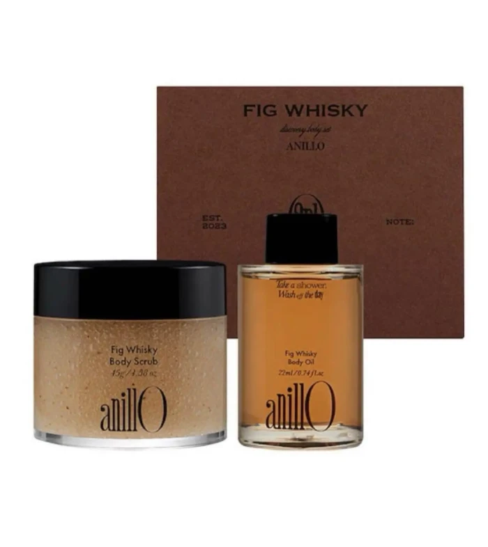 Fig Whisky skincare trio: a jar of body scrub and a bottle of body oil in front of a brown gift box.