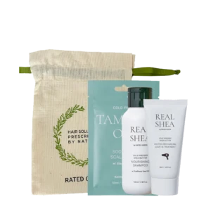 Hair care kit with a beige drawstring pouch and three Real Shea products (two bottles and a tube) in front of teal packaging behind them.