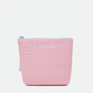 Close-up of a pink zippered pouch with a light blue zipper pull and 'DARLING' printed in white on the front.