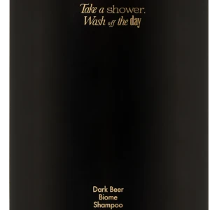 Black pump shampoo bottle with gold text: 'Take a shower, Wash off the day' and 'Dark Beer Biome Shampoo'