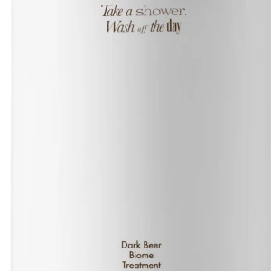 White pump bottle with a black nozzle, featuring brown text: 'Take a shower, Wash off the day' and 'Dark Beer Biome Treatment' 500 ml.
