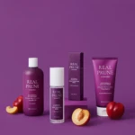 Purple-background product photo showing Real Prune haircare line: shampoo, conditioner, and tubes with plums nearby