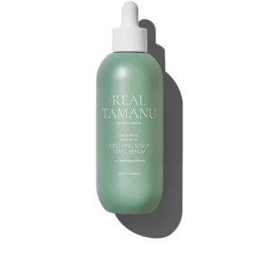 Mint-green spray bottle labeled 'REAL TAMANU' with white pump, reading 'Soothing Scalp Tonic Serum' against a black background.