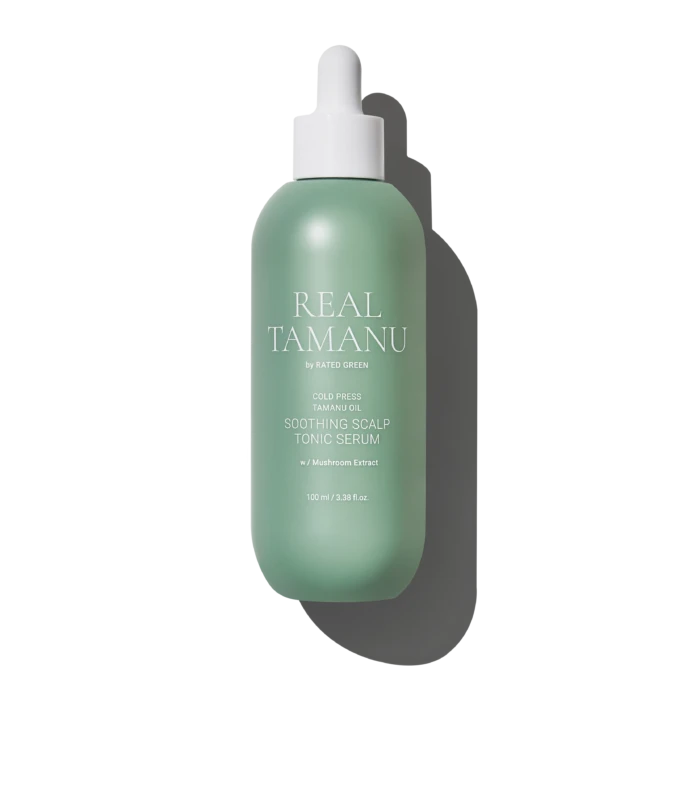 Mint-green spray bottle labeled 'REAL TAMANU' with white pump, reading 'Soothing Scalp Tonic Serum' against a black background.