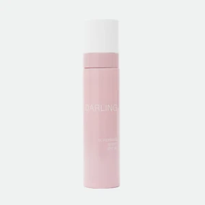 Close-up of a pink lipstick bottle with a white cap, standing upright; the word 'DARLING' appears on the container.