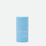 Blue cylindrical sunscreen stick labeled 'DARLING' with SPF 50+ visible on the front.