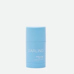 Blue cylindrical sunscreen stick labeled 'DARLING' with SPF 50+ visible on the front.