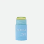Blue sunscreen stick with a light green cap, labeled 'DARLING' and SPF 50+ (Clear Sun Stick) visible on the label.