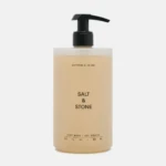 Beige Salt & Stone body wash bottle with a black pump dispenser.
