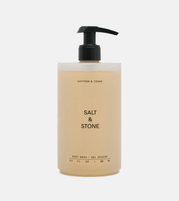 Beige Salt & Stone body wash bottle with a black pump dispenser.