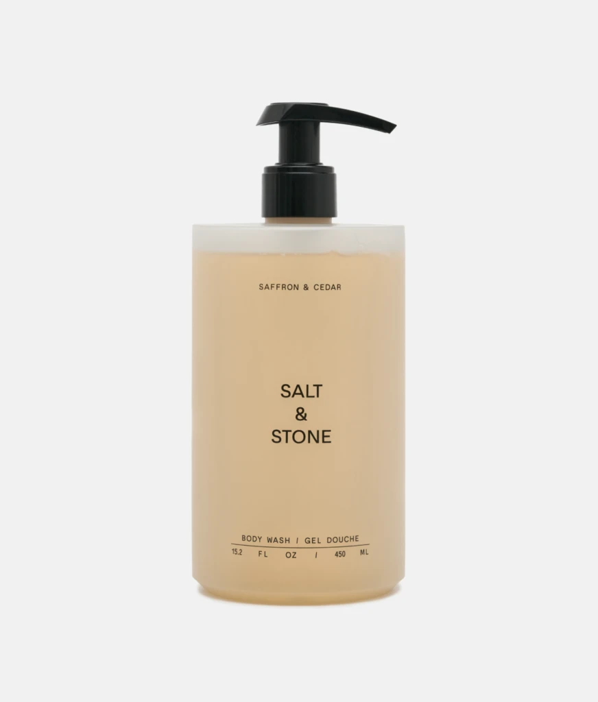 Beige Salt & Stone body wash bottle with a black pump dispenser.