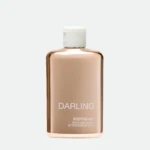 Rose-gold Darling bottle with white cap, labeled 'DARLING' and 'SOOTHE-ME FACE AND BODY AFTER-SUN LOTION'