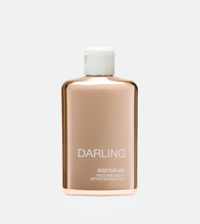 Rose-gold Darling bottle with white cap, labeled 'DARLING' and 'SOOTHE-ME FACE AND BODY AFTER-SUN LOTION'